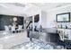 Spacious living room featuring a sleek piano, elegant dining set, staircase, and modern decor at 10542 Wittenberg Way, Orlando, FL 32832