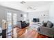Bright and airy living room featuring hardwood floors and access to a balcony at 10542 Wittenberg Way, Orlando, FL 32832