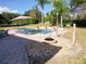 Beautiful backyard featuring a luxurious pool, brick patio, fire pit, and well-maintained landscaping at 10542 Wittenberg Way, Orlando, FL 32832