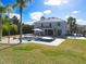 Backyard view of a private pool surrounded by lush greenery, a lounge area, and a well-manicured lawn at 10542 Wittenberg Way, Orlando, FL 32832