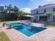 Backyard featuring a large swimming pool with patio, outdoor seating, and lush landscaping at 10542 Wittenberg Way, Orlando, FL 32832