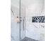 Walk-in shower with marble wall tile and decorative shower niche at 10542 Wittenberg Way, Orlando, FL 32832