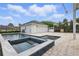 A backyard pool and hot tub with a detached garage and basketball hoop at 1338 Union Club Dr, Winter Garden, FL 34787