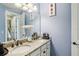 Bathroom featuring double sinks, granite countertops, with framed mirror and modern fixtures at 14132 Murcott Blossom Blvd, Winter Garden, FL 34787