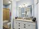 Bathroom featuring double sinks, granite countertops, and a separate shower and toilet area at 14132 Murcott Blossom Blvd, Winter Garden, FL 34787