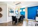 Elegant dining area with modern lighting and a stylish table set against a blue accent wall at 14132 Murcott Blossom Blvd, Winter Garden, FL 34787