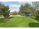 Enjoy the sunny front yard of this lovely home with a green lawn and mature trees at 14132 Murcott Blossom Blvd, Winter Garden, FL 34787