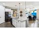 Modern kitchen island with granite countertop and stainless steel appliances, open to dining area at 14132 Murcott Blossom Blvd, Winter Garden, FL 34787