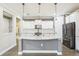 Bright kitchen featuring a spacious island, white cabinets, and modern appliances at 14132 Murcott Blossom Blvd, Winter Garden, FL 34787