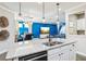 Bright kitchen with a large granite island, stainless steel appliances, and open to dining and living area at 14132 Murcott Blossom Blvd, Winter Garden, FL 34787