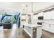 Modern kitchen with a center island, pendant lighting, and seamless flow into the living area at 14132 Murcott Blossom Blvd, Winter Garden, FL 34787