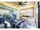This screened lanai has an outdoor kitchen, grill, and dining table; open the sliding doors to the inside at 14132 Murcott Blossom Blvd, Winter Garden, FL 34787