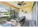 This screened lanai features a dining table, bench, and open windows so you can dine outdoors at 14132 Murcott Blossom Blvd, Winter Garden, FL 34787