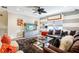 Comfortable living room with striped walls, plush seating, large television and modern decor at 14132 Murcott Blossom Blvd, Winter Garden, FL 34787