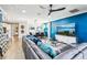 Bright and open living area featuring hardwood floors, a blue accent wall, and modern furnishings at 14132 Murcott Blossom Blvd, Winter Garden, FL 34787