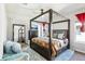 This main bedroom has a beautiful canopy bed, large mirror, and a ceiling fan at 14132 Murcott Blossom Blvd, Winter Garden, FL 34787