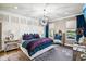 Luxurious main bedroom with unique chandelier, tufted headboard and mirrored nightstands at 14132 Murcott Blossom Blvd, Winter Garden, FL 34787