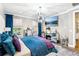 Bright main bedroom with a unique chandelier, views from the window and mirrored dressers at 14132 Murcott Blossom Blvd, Winter Garden, FL 34787