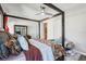 This is the main bedroom with a ceiling fan, a big bed, and a sliding door to the bath at 14132 Murcott Blossom Blvd, Winter Garden, FL 34787