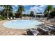 Community splash pad with surrounding lounge chairs on a brick patio with a black metal fence and palm trees at 14132 Murcott Blossom Blvd, Winter Garden, FL 34787