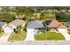 Aerial view of a charming neighborhood showcasing well-maintained homes, mature trees, and lush green lawns at 4245 Arlington Ridge Blvd, Leesburg, FL 34748