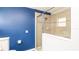 Bathroom featuring a glass shower with tan tiling and blue painted walls at 4245 Arlington Ridge Blvd, Leesburg, FL 34748