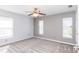 Bedroom with carpet, two windows, and ceiling fan with lights at 4245 Arlington Ridge Blvd, Leesburg, FL 34748