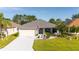 Charming single-story home featuring a manicured lawn and attached two-car garage at 4245 Arlington Ridge Blvd, Leesburg, FL 34748