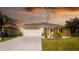 Well-maintained exterior with a prominent flag, tidy landscaping, and an inviting entrance at 4245 Arlington Ridge Blvd, Leesburg, FL 34748