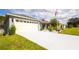 Charming home with a well-maintained lawn and a spacious driveway leading to a two-car garage at 4245 Arlington Ridge Blvd, Leesburg, FL 34748