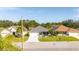 Charming home with manicured lawn and landscaping viewed from a low aerial perspective at 4245 Arlington Ridge Blvd, Leesburg, FL 34748