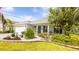 Charming single-story home with a well-manicured lawn and rock garden at 4245 Arlington Ridge Blvd, Leesburg, FL 34748