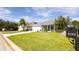 Charming single-story home featuring a well-manicured lawn, a two-car garage, and beautiful landscaping at 4245 Arlington Ridge Blvd, Leesburg, FL 34748