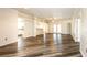 Open concept living and dining room with wood flooring, white walls and trim, and kitchen views at 4245 Arlington Ridge Blvd, Leesburg, FL 34748