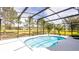 Beautiful screened-in pool with a picturesque view of the green lawn and surrounding landscape at 4245 Arlington Ridge Blvd, Leesburg, FL 34748