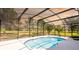Refreshing pool with a screened enclosure and view of the open green yard, perfect for summer fun at 4245 Arlington Ridge Blvd, Leesburg, FL 34748