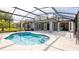 Sparkling in-ground pool with an oversized screen and view of the home's back exterior at 4245 Arlington Ridge Blvd, Leesburg, FL 34748