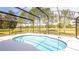 Beautiful screened-in pool with stunning views of the green common area at 4245 Arlington Ridge Blvd, Leesburg, FL 34748