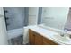 Bathroom with wood vanity cabinets and black-and-white tiled walls at 261 Dublin Dr, Lake Mary, FL 32746