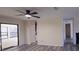 Bright living room with ceiling fan, light grey wood floors, and open access to kitchen and backyard at 261 Dublin Dr, Lake Mary, FL 32746