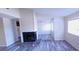 Living room features a decorative fireplace, multiple windows, and new gray laminate flooring at 261 Dublin Dr, Lake Mary, FL 32746