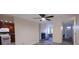 Bright living room with ceiling fan, fireplace, light grey wood floors, and open access to kitchen and front entry at 261 Dublin Dr, Lake Mary, FL 32746