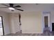Bright living room with ceiling fan, light grey wood floors, and open access to kitchen at 261 Dublin Dr, Lake Mary, FL 32746