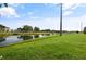 Backyard featuring a tranquil pond and lush green grass at 5783 Peregrine Ave # C07, Orlando, FL 32819