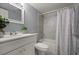 Bathroom featuring a sink, toilet, and shower with a curtain at 5783 Peregrine Ave # C07, Orlando, FL 32819