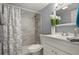 Bathroom featuring a sink, toilet, and shower with a curtain at 5783 Peregrine Ave # C07, Orlando, FL 32819