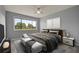 Comfortable bedroom with large window, ceiling fan, neutral walls and floors, and stylish furnishings at 5783 Peregrine Ave # C07, Orlando, FL 32819