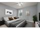 Nicely decorated bedroom featuring neutral walls and floors, ceiling fan, and a large window at 5783 Peregrine Ave # C07, Orlando, FL 32819