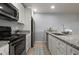 Well-equipped kitchen featuring modern appliances, granite countertops, and ample cabinet space at 5783 Peregrine Ave # C07, Orlando, FL 32819