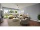 Bright living room with large windows, comfortable seating, and a stylish rug, perfect for relaxation at 5783 Peregrine Ave # C07, Orlando, FL 32819